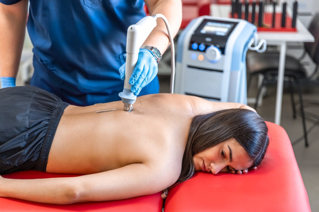 Shockwave therapy treatment applied to patient’s back